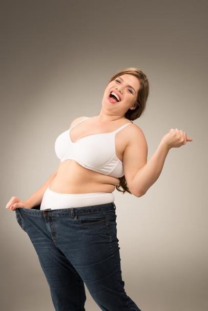 stock-photo-happy-overweight-woman-in-jeans